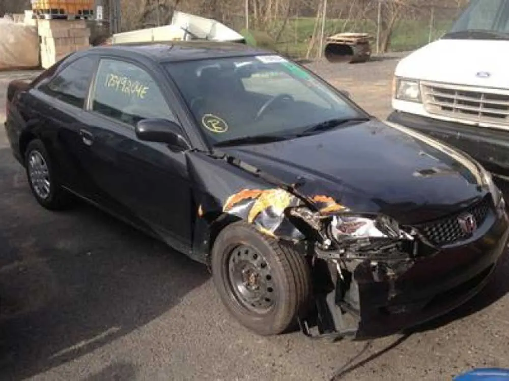 Black Honda with damaged front end
